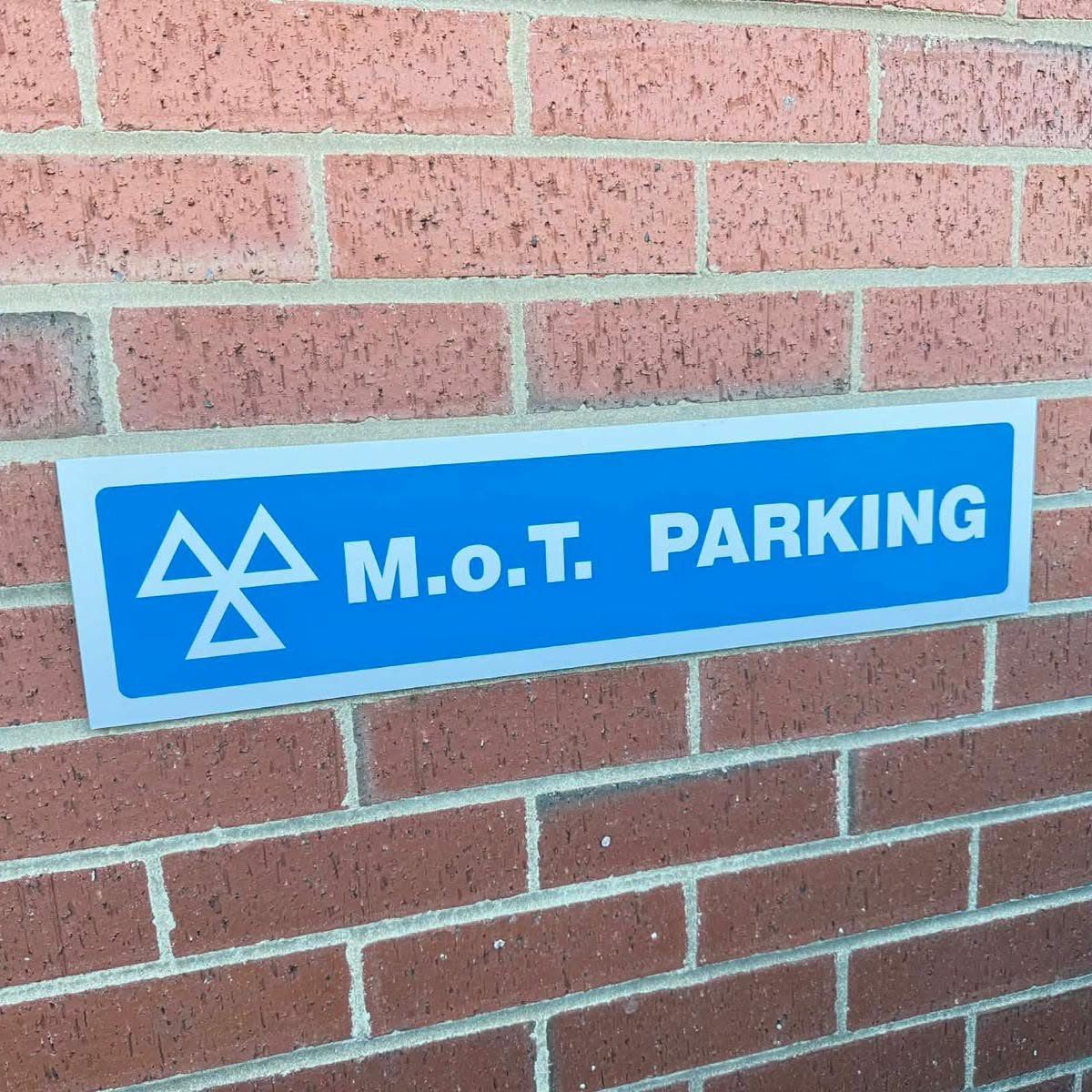 MOT parking sign on the brick wall outside the workshop